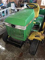 Front quarter view showing green hood with model decal, grille and front tires