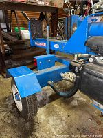 Towable chassis and wheel assembly with Wallenstein branding