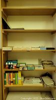 Shelf with boxes, stamp dictionaries, ink bottles, loose papers