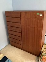 Front view showing eight stacked drawers on left and single door on right