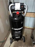 Front view of the entire compressor showing tank, handle and wheels