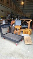 Photo showing black painted large rolling cart with shelf and red caster wheels, along with smaller wooden items including dog bed frames and wooden boxes.