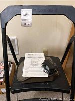 Gorilla Ladders step stool with Moultrie game camera and charger/manual on top