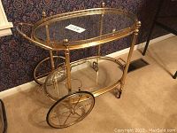 Front view showing entire tea cart, two tiers, and wheels