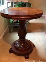 Full view of round top and carved pineapple pedestal base