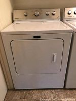 Full front view of white Maytag dryer with door closed and control panel visible.
