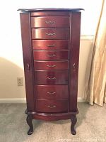 Front view of closed armoire showing full piece and cabriole legs