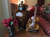 Photo of entire lot showing ginger jar, glass violin lamp, and urn with silk roses on wooden table