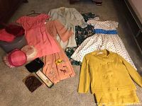 Overall view of hats, purses, jewelry, suits and dresses on floor