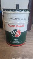 Front view of vintage 5 gallon metal oil can showing B/A logo, 'Quality Products' text, and general condition.