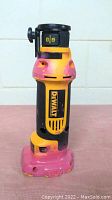 Front view of the DeWalt 18V router cordless tool body showing black and yellow casing with pink paint marks.