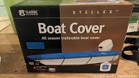 Front of the box showing brand Classic Accessories and Stellex, stating it is an all season trailerable boat cover for 14'-16' boats.
