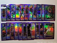 Photo showing all 22 Donruss Optic NBA cards with purple borders laid out in two rows, featuring multiple players.