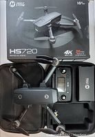 Holy Stone HS720 drone with remote control, carrying case, and original packaging box