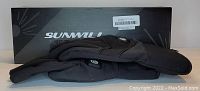 Photo of two black Sunwill rechargeable heated gloves laid flat with the Sunwill branded box placed behind them.