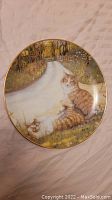 Front view of 'The May Queen' decorative plate featuring cat illustration with fall foliage background