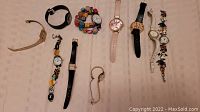Overview of 10 women's watches with various strap types and colors, showing the variety in the lot.