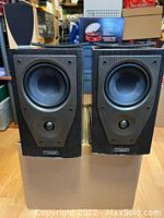 Pair of Mission M71 bookshelf speakers front view without grills showing the woofer and tweeter drivers
