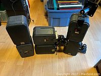 Six JBL Pro III speakers arranged on floor with some metal mounting brackets visible behind.
