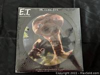 Front of sealed picture disc vinyl LP showing E.T. image on disc with black cover featuring title.