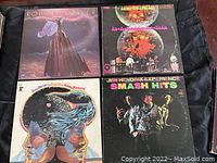 Four vinyl LP record covers: Robin Trower "Passion," Iron Butterfly "In-A-Gadda-Da-Vida," Jimi Hendrix Experience "Smash Hits," and Jimi Hendrix with Little Richard album.