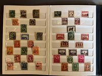 Two open stockbook pages showing 69 used Newfoundland stamps of various designs and colors.