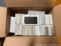 Box filled with approximately 2,000 white stamp cards organized in rows.