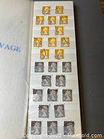 Photo of a stock book page containing yellow, black, and gray Machin stamps from Great Britain, all used with postmarks.