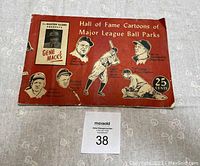 Photo of front cover of the book showing title, cartoons of Major League Baseball figures, and price 25 cents.