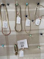 Top view of all 5 pieces pinned to cork board with tags describing length, width and weight