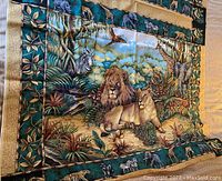 Top view photo showing detailed jungle animal print featuring lions, zebras, and lush foliage on fabric panel.
