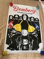 Full view of large poster with stylized illustration of five men on motorcycles, with visible condition issues at edges.
