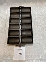 Vintage cast iron mini loaf pan with 12 small loaf compartments front view