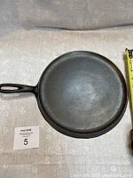 Top view of 11-inch cast iron griddle showing cooking surface and handle