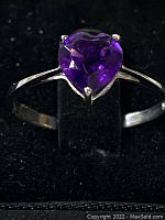 Front view of the sterling silver ring with heart-shaped amethyst and its deep purple color.