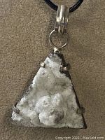 Full pendant view on black cord showing triangular druzy crystal mineral set in 925 sterling silver.