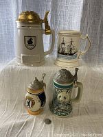 Front view of four vintage drinking steins showing Okeefe, schooner, Berlin Moustache Cub, and Avon Panda steins.