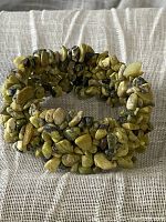 Full view of the woven jasper chip stretch bracelet showing its coiled shape and overall construction.