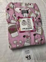 Front view of folded Joe Boxer ladies 2-piece pajama set, size Large, with product label visible.