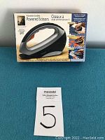 Original retail box for Innovage Automatic/Cordless Powered Scissors showing product features and usage examples.