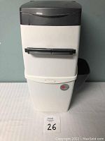 Front view of white and gray cat litter disposal system with horizontal handle and measuring approximately 18 inches tall.