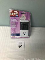 Front view of Garrison ADT programmable digital timer in original packaging showing digital display, buttons, and outlet socket