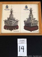 Front view of the framed picture depicting the stern and bow of H.M.S. Hood from 1941 with clear text and wooden frame.
