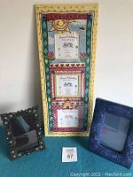 Three picture frames displayed: a vertical 8x20 frame holding 3 pictures with colorful whimsical border, a dark blue ornate frame, and a jeweled metal frame.