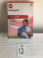 Photo of box packaging showing Life brand heating pad for deep muscle and joint pain relief, king size pad 10 x 24 inches, and key features such as 3 heat settings, automatic shut-off, and machine washable cover.