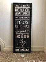 Front view of the black background canvas wall art with white motivational text and metal frame.