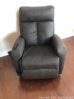 Front view of chair upright with remote on right arm