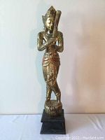 Full front image of the gold-painted large goddess figurine against a white background showing entire figure and base.