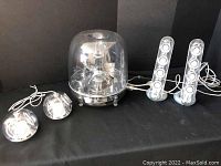 All components: transparent dome subwoofer, two cylindrical satellites, two spherical satellites