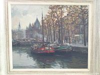 Front view of the framed oil painting showing canal with boats, trees, buildings.